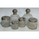 A pair of clear glass hobnail cut scent bottles, silver covers, Birmingham 1908; other similar