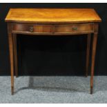 A George III style bow front mahogany side table, oversailing top above two short cockbeaded