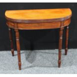 A George III mahogany demilune tea table, hinged top with reeded edge, above a deep frieze, turned