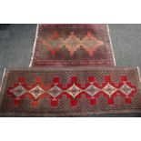 A rectangular Middle Eastern carpet, stylised flowers and geometric motifs, 280cm long, 94cm wide;