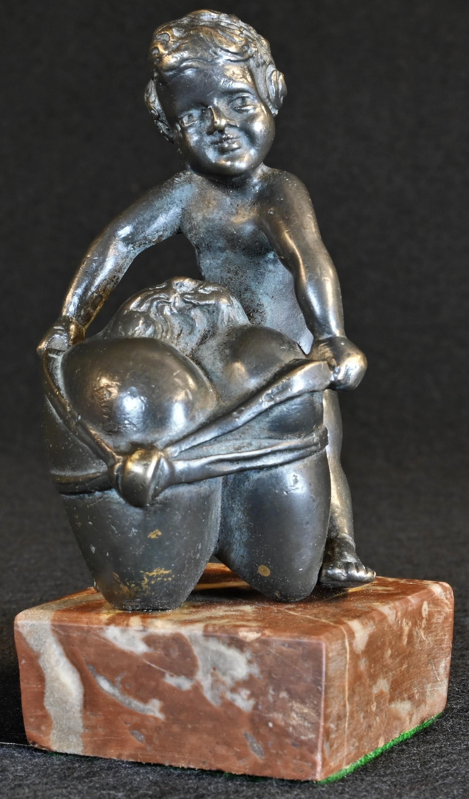 Continental School (19th century), a dark patinated bronze, of a putto holding a Sacred Heart,