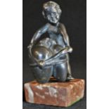 Continental School (19th century), a dark patinated bronze, of a putto holding a Sacred Heart,
