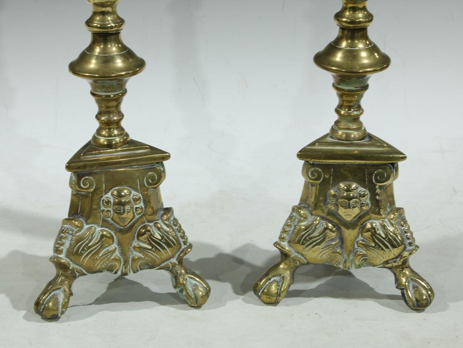 A pair of brass candlesticks, converted for electricity as table lamps, tripod bases, the brass - Image 2 of 3