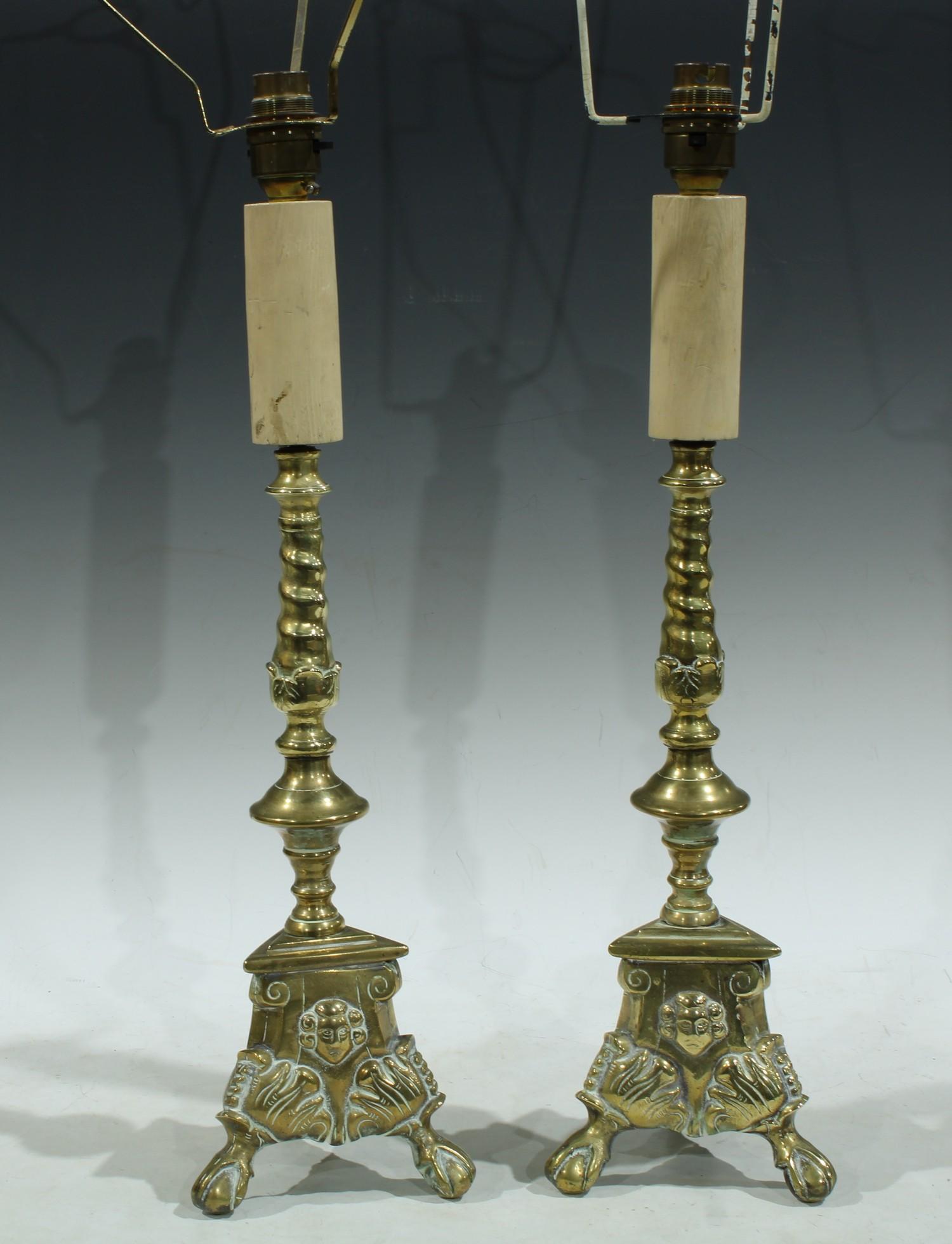 A pair of brass candlesticks, converted for electricity as table lamps, tripod bases, the brass - Image 3 of 3