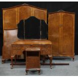 A 20th century art deco burr walnut veneered bedroom suite, comprising a triple wardrobe, Hunters of