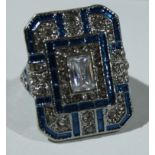 An Art Deco style base metal dress ring, blue enamel and white glass stones, size J, boxed