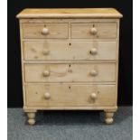A farmhouse pine chest of drawers, oversailing rectangular top above two short and three long