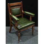 An Edwardian mahogany open arm chair, stuffed over leather upholstery, turned forelegs, sabre back