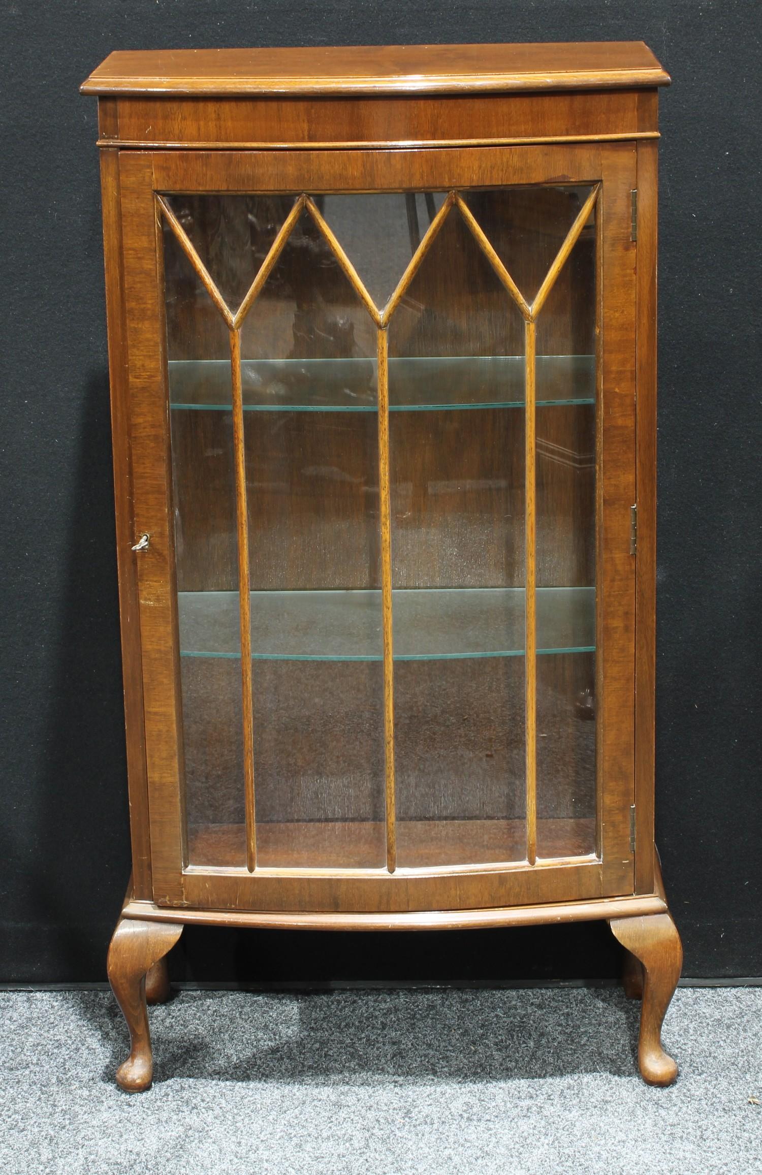 A Hunters of Derby mahogany bow front display cabinet, glazed door enclosing glass shelves, cabriole