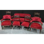 A late Victorian mahogany seven piece salon suite, comprising a sofa, a pair of armchairs , a pair