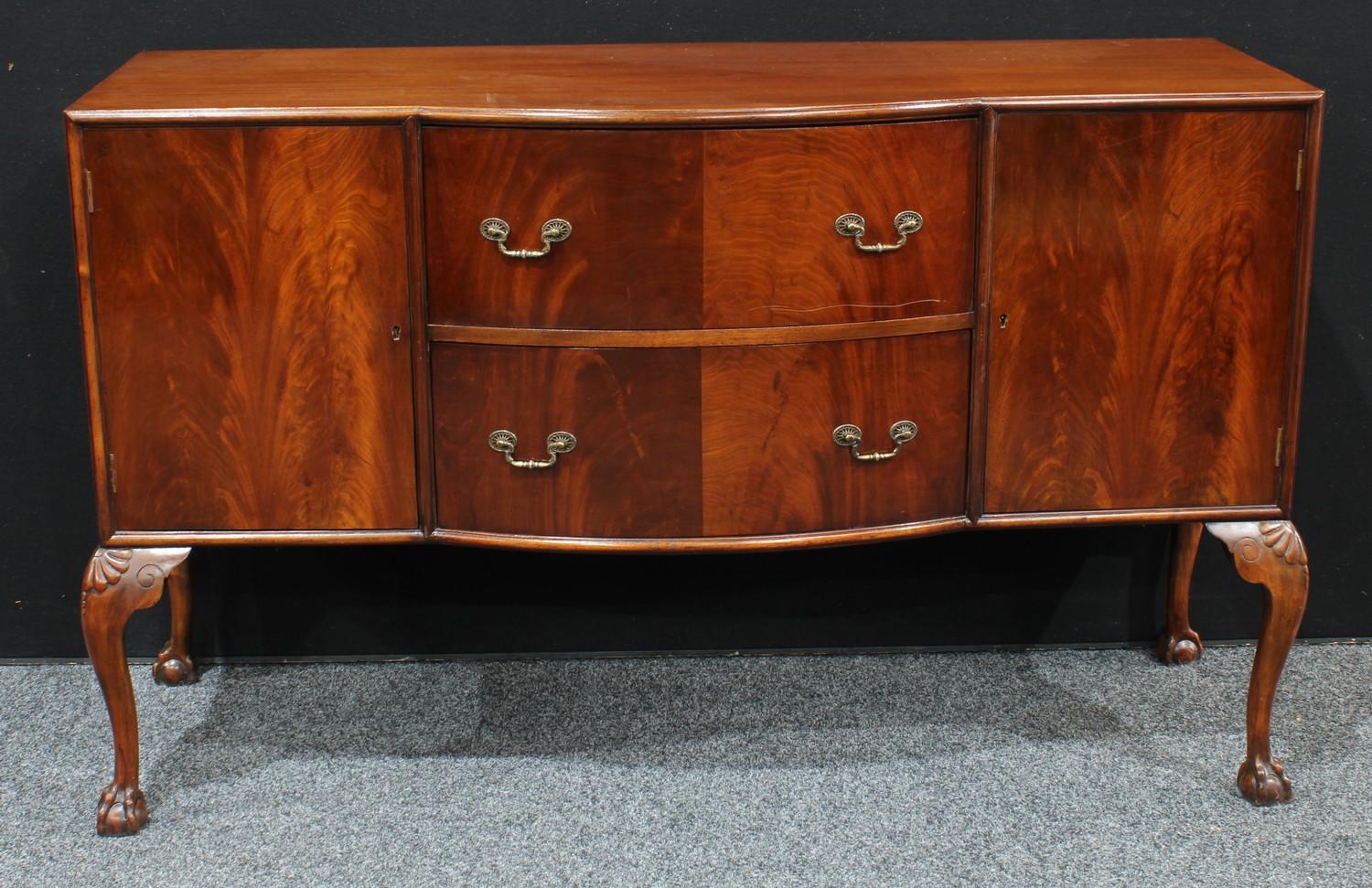 A Queen Anne design mahogany side board, center bow front top above two drawers and two cupboard