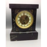 Slate key wind mantle clock with enamel face and marbled detailing, with key