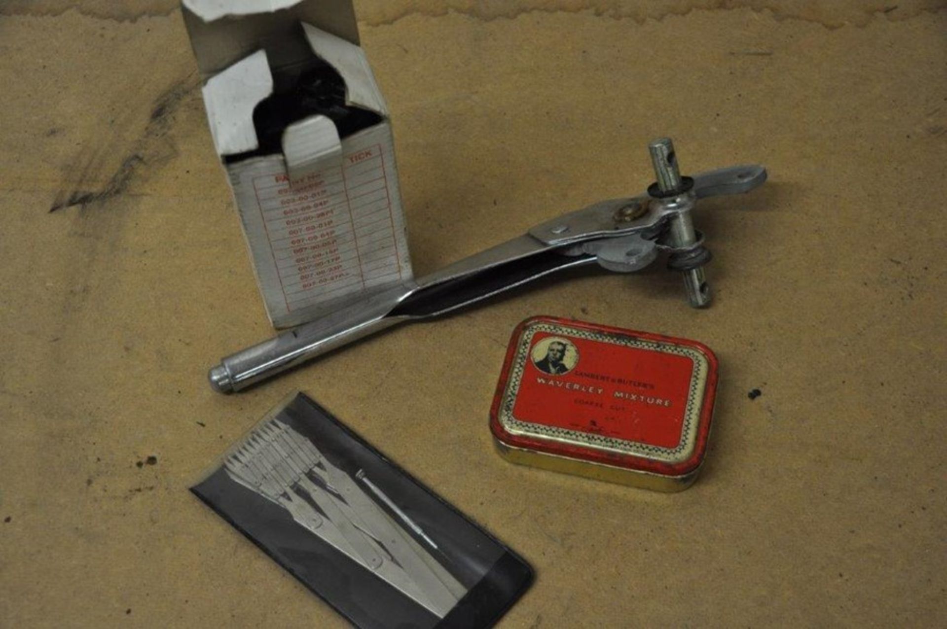 A Racal Battery in box, Waverley Mixture Tin, a metal instrument and one other.