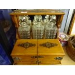 Decorative oak Tantalus with lockable compartments and key plus 3 decanters