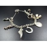 Silver and white metal charm bracelet on silver chain, 32g gross
