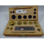 Set of 9 brass weights in wooden box