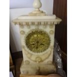 A rose and alabaster mantle clock with brass/ormlou face with roman numerals striking on half hour