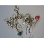 White metal chain link charm bracelet containing a number of enamelled and decorative charms