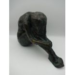 Bronze figure of a nude sitting, signed W. E. 95, 30cm long