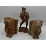 Pair of wooden lion bookends plus wooden figure of a pipe smoking gentleman