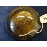 A round relief portrait in gilt metal signed ?ogch f 1827