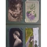Large folder of vintage postcards containing portraits, landscapes and greetings cards, plus some