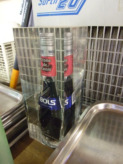 Bottle of Bols set in resin