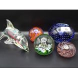 5 pieces of glass to include dolphin figure and 4 paperweights, one of which is Caithness Fiesta,