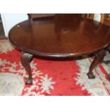 Mahogany wind out table on ball and claw feet with one leaf 52 inches closed leaf is 18 1/2 wide