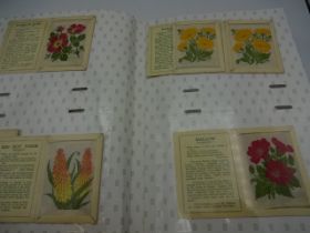 Album of Kensitas flower silk cigarette cards containing a mixed collection of small and large