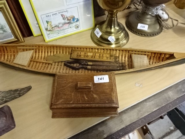 Treen to include storage box, vintage rule and nutcrackers plus canoe model, 65cm long