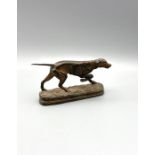 A bronzed cast metal sculpture of a working pointer dog 14cm long by 8cm tall with stamped signature