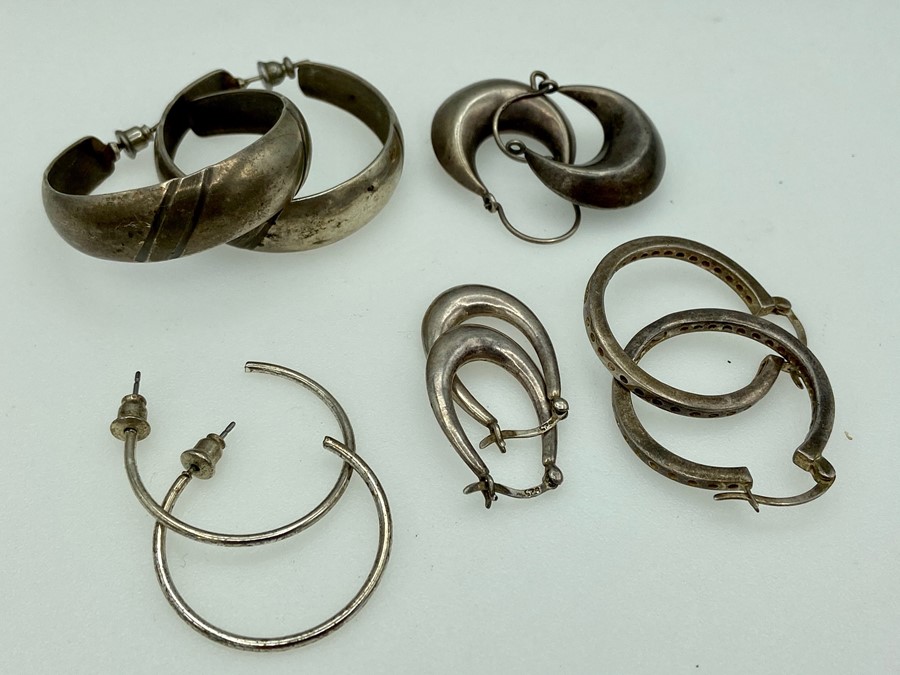 Five pairs of silver hoop earings