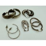 Five pairs of silver hoop earings