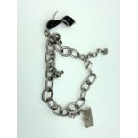 A charm bracelet with stiletto shoe and hangbag