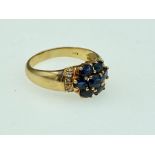 An 18ct (.750) cluster sapphire ring