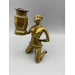 A Brass figure of an African woman holding a pot, 20cm tall