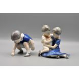 Royal Copenhagen porcelain figures to include: brother and sister cuddling, 12 cm tall and boy