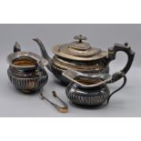 A good quality silverplate tea service comprising of a silver plate teapot, creamer, sugar tongues