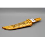 A JAPANESE CARVED BONE DAGGER WITH CASE DECORATED WITH DRAGONS AND BIRDS