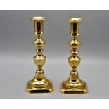 A pair of 18th century brass candle stick holders, approximately 20cm tall
