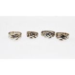 Four sterling silver puzzle rings