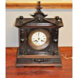Late 19th century mantle clock in oak temple-shaped case with key and pendulum 45cm tall