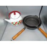Two modern wooden handled cast iron skillets 8 and 10 inch plus stove top kettle