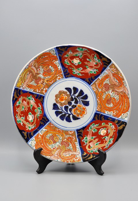 An antique Japanese Imari plate with "gold" decorated central flower and panels with honey pot and