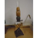 Oil lamp with cast iron base and glass reservoir