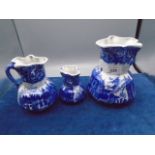 3 graduated blue and white jugs