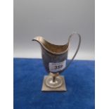 A fine silver helmet-shaped cream jug with engraved crest on a square base, 5" high, 100gms