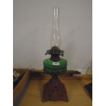 Oil lamp with cast iron base and glass reservoir