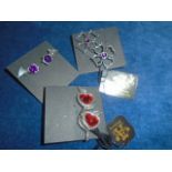 3 pairs of earrings made with Swarovski crystal elements in the shape of hearts, flowers and bats